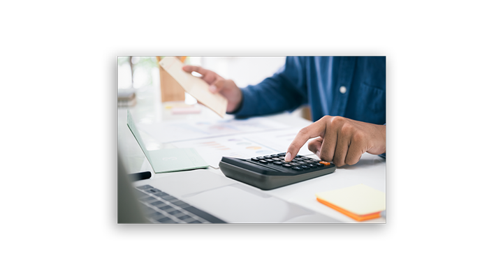 accountant using calculator at desk